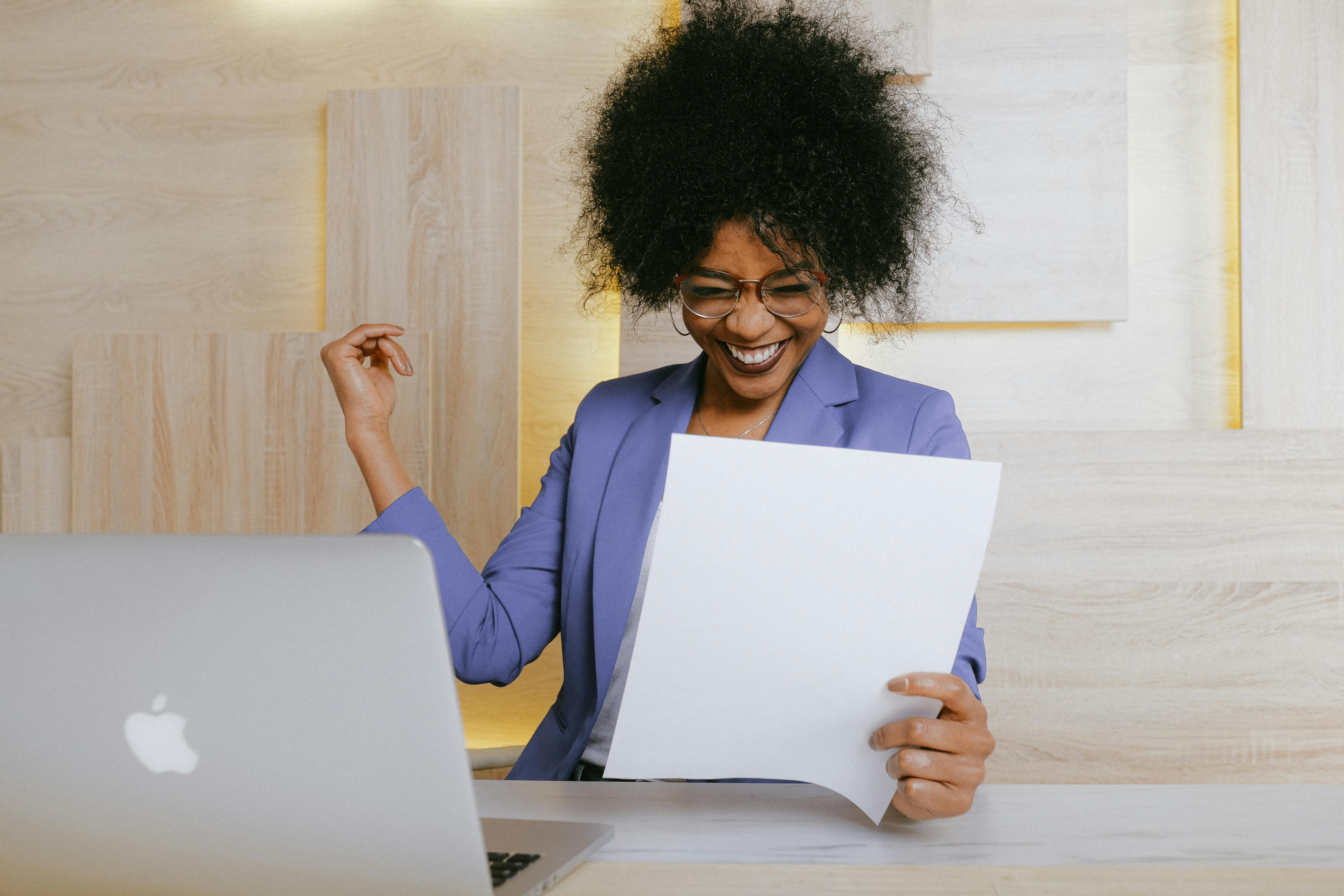 Businesswoman smiling while reviewing a document, symbolizing the efficiency gains from Intelligent Document Processing with AI.